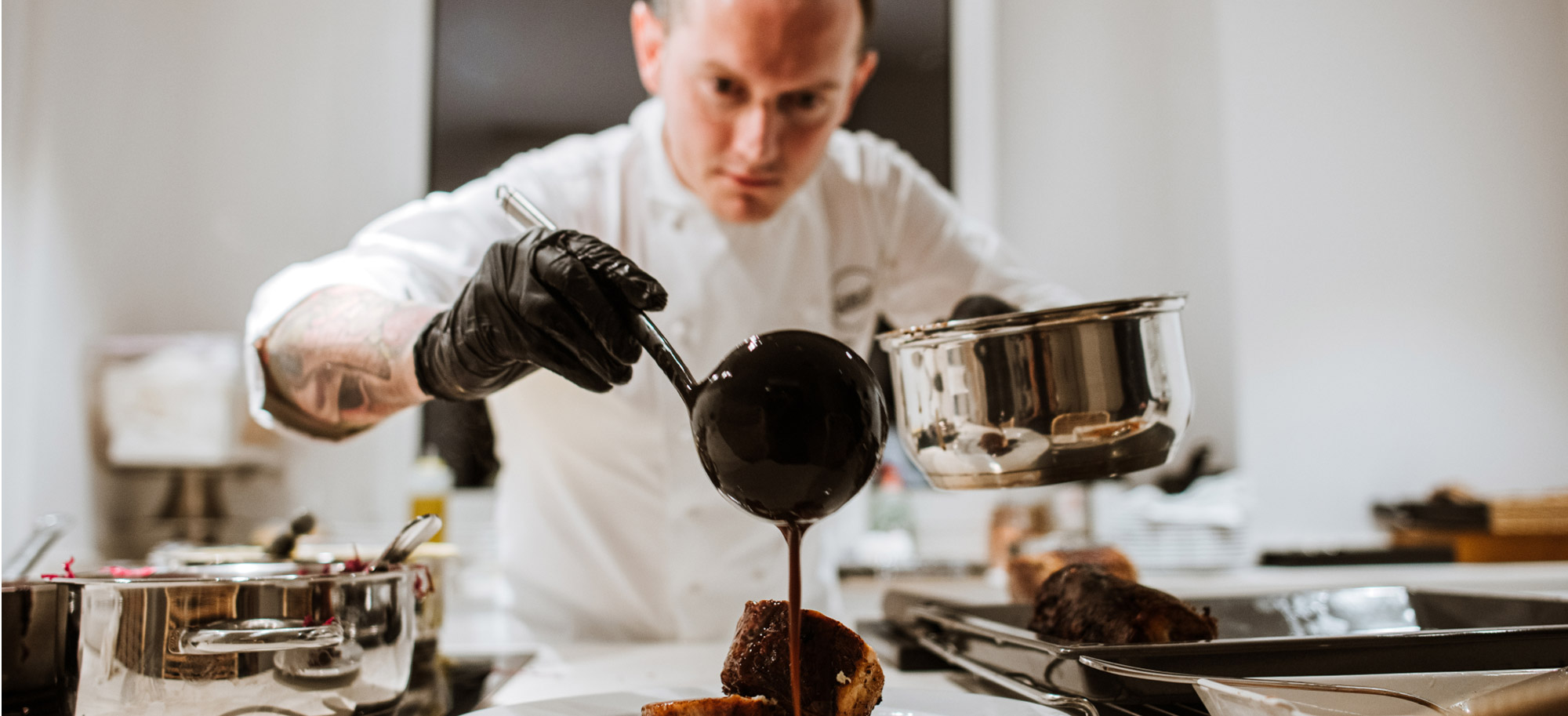 Private chef finishing a dish