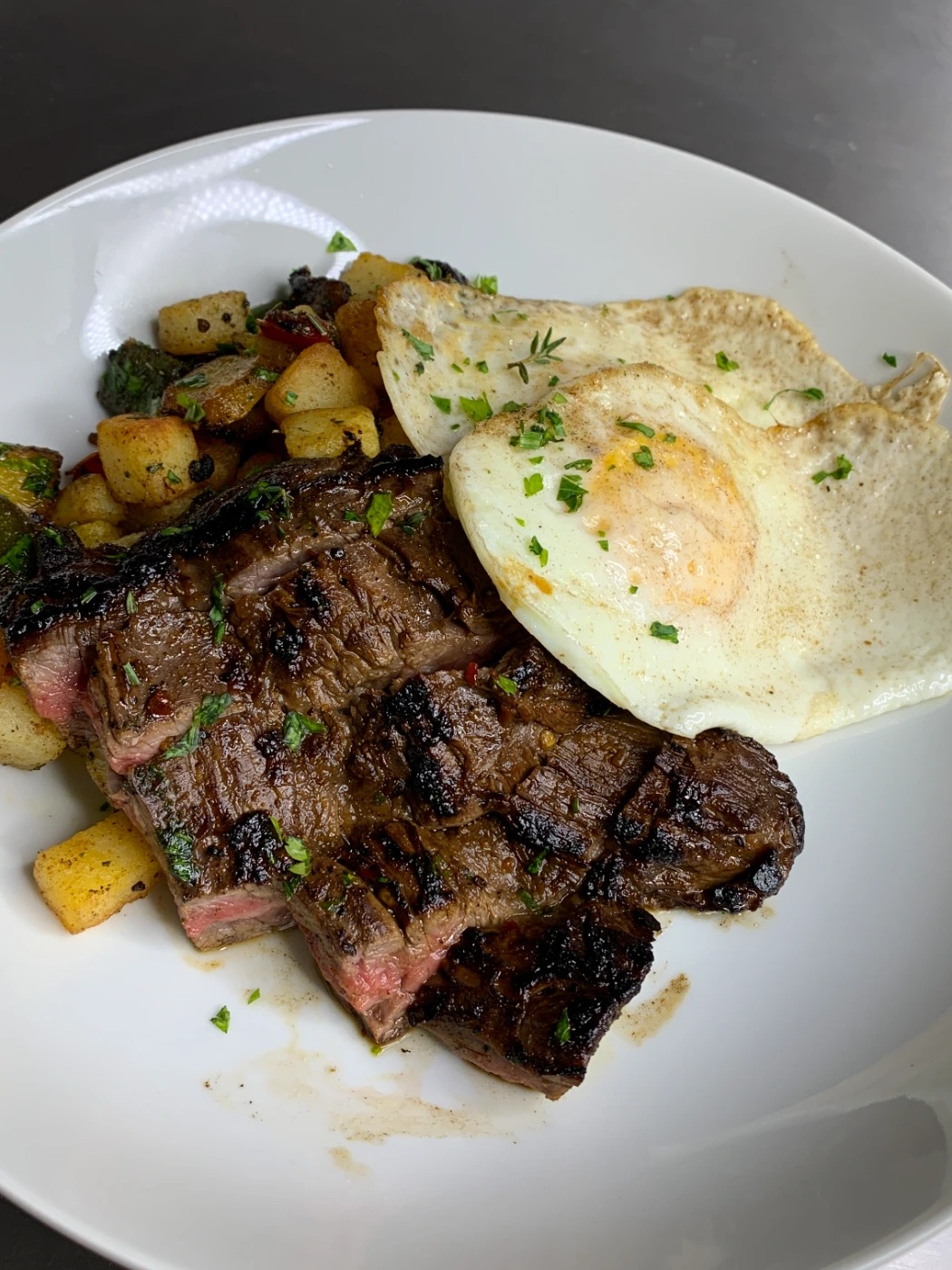 marinated and grilled skirt, over medium eggs, garlic and herb breakfast potatoes.JPG marinated and grilled skirt, over medium eggs, garlic and herb breakfast potatoes.JPG