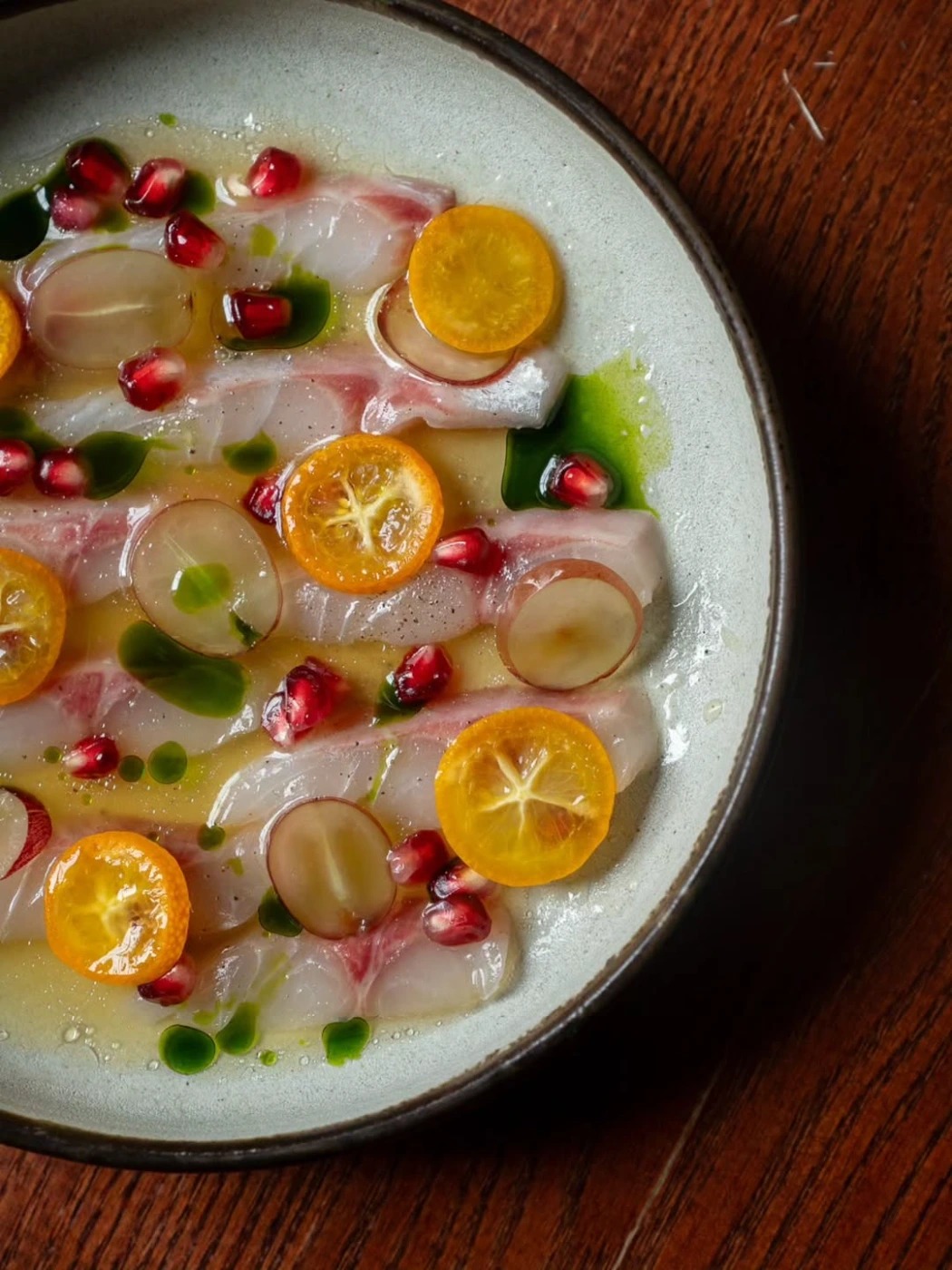 Sea bream carpaccio, pickled kumquats, red grapes and pomegranate..heic.jpg