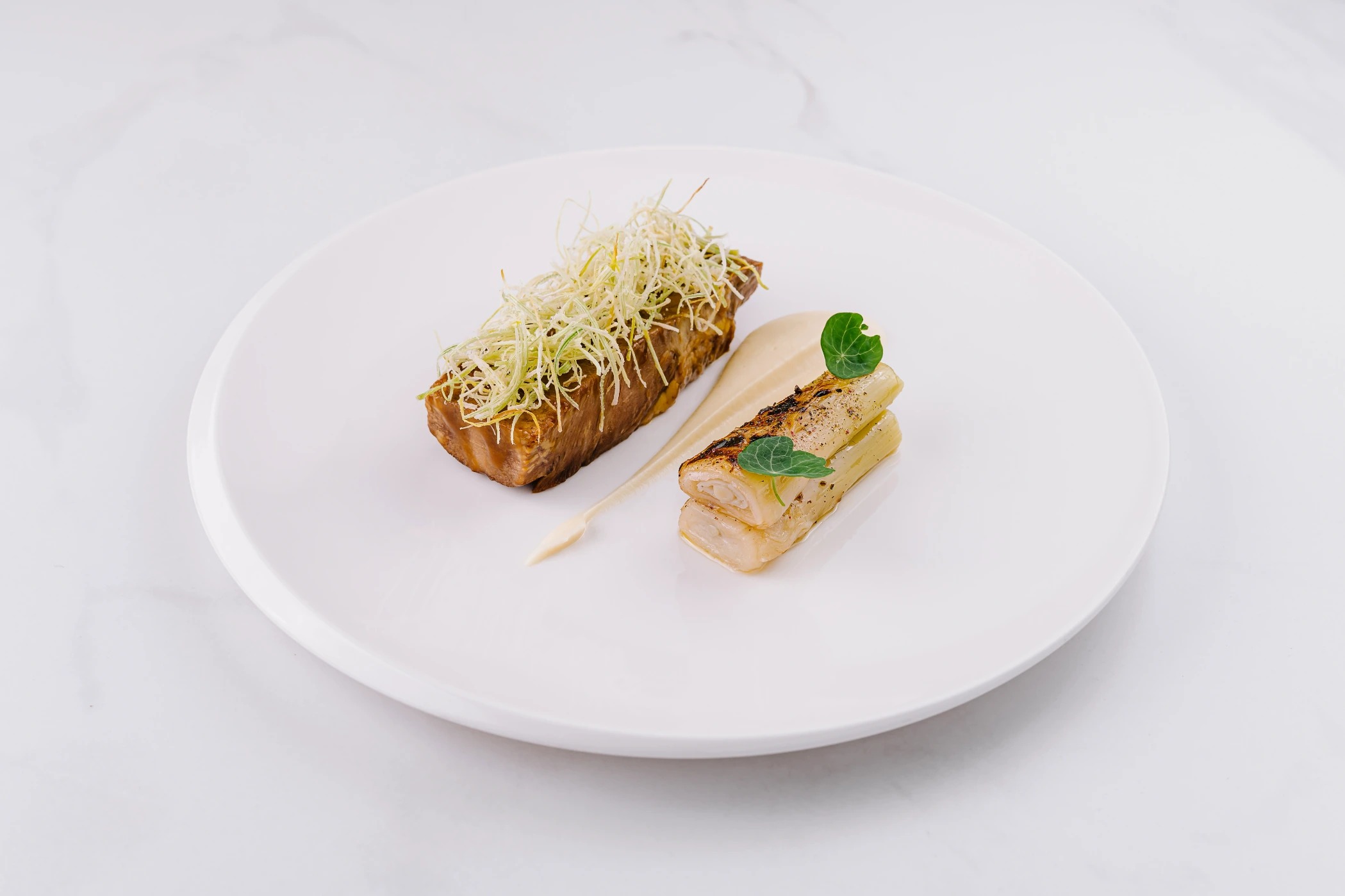 gourmet-leek-and-potato-dish-on-white-plate-2025-02-22-15-06-59-utc (1).jpg