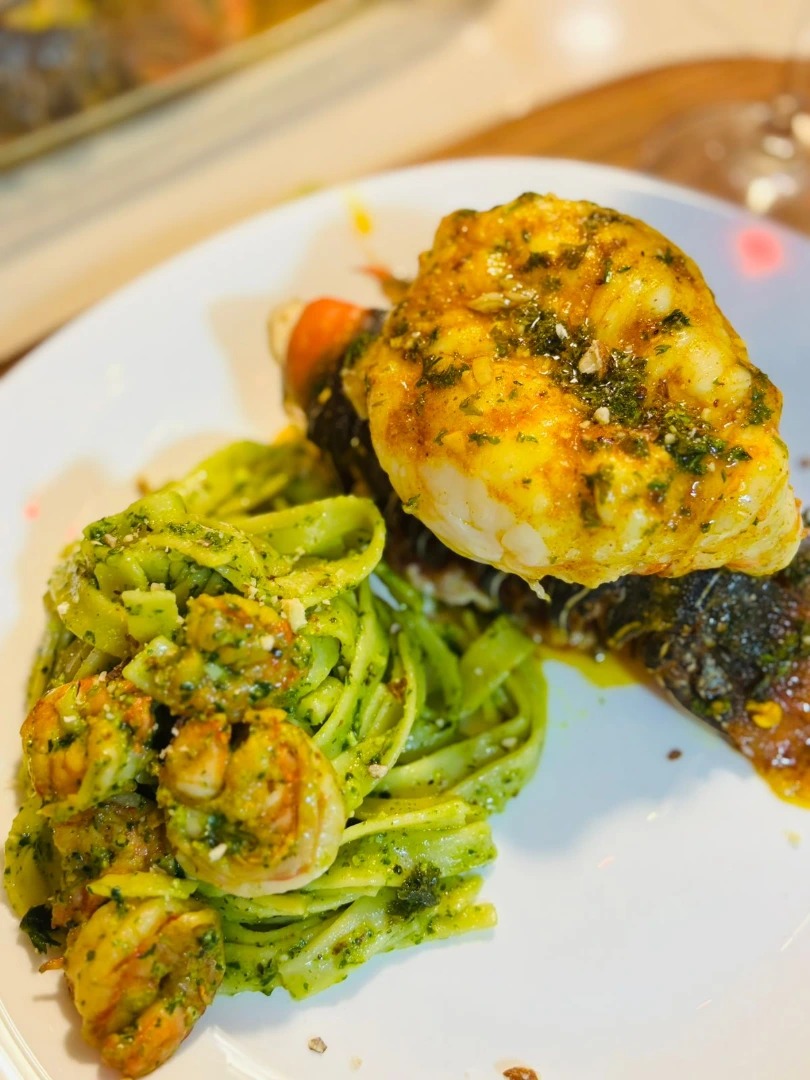 Langosta y camarones con pesto clásico y notas cítricas.