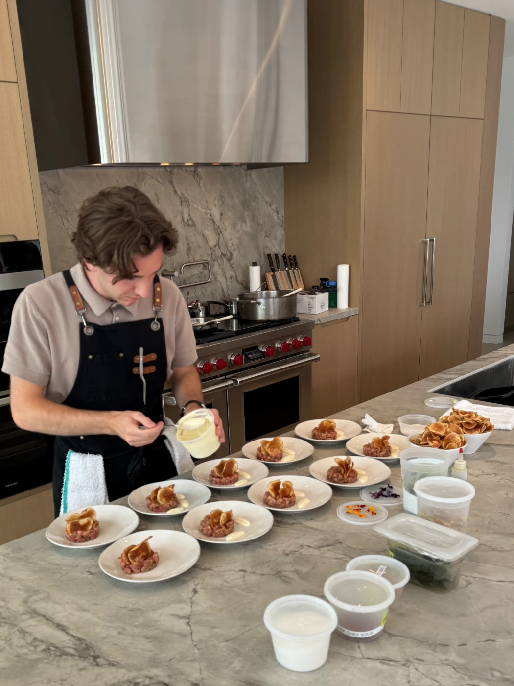 tuna tartare getting plated with chef.jpg