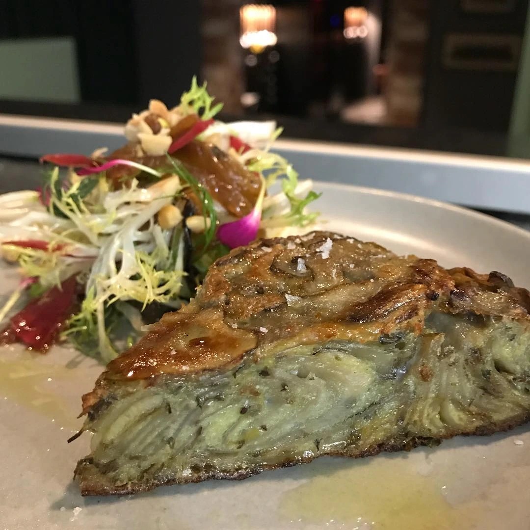 Sunchoke and leek tortilla espanola, frisée, caramelized onions( in schmaltz) pickled carrots, toasted hazelnuts, shallot bacon vinaigrette..jpg