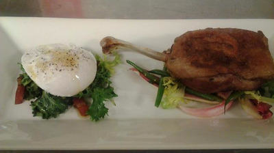 On the right pan seared confited duck leg that is on top of free lettuce green beans and radiccho lettuce on the left sous vide duck egg on top of chickory greens and Benson's bacon bits everything except the d