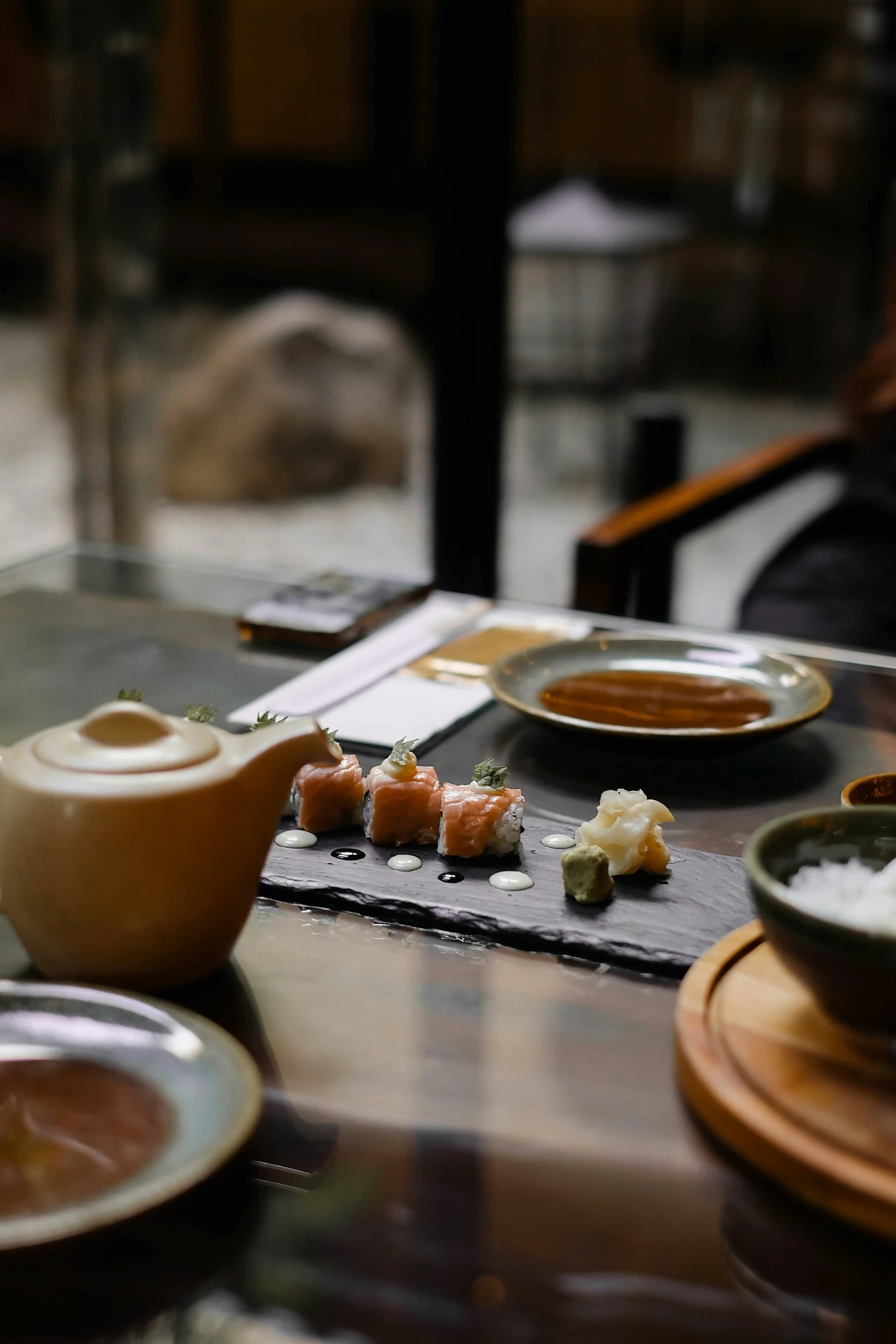 An assorted sushi dinner with different Japanese dishes served and garnished with sauces and vegetables