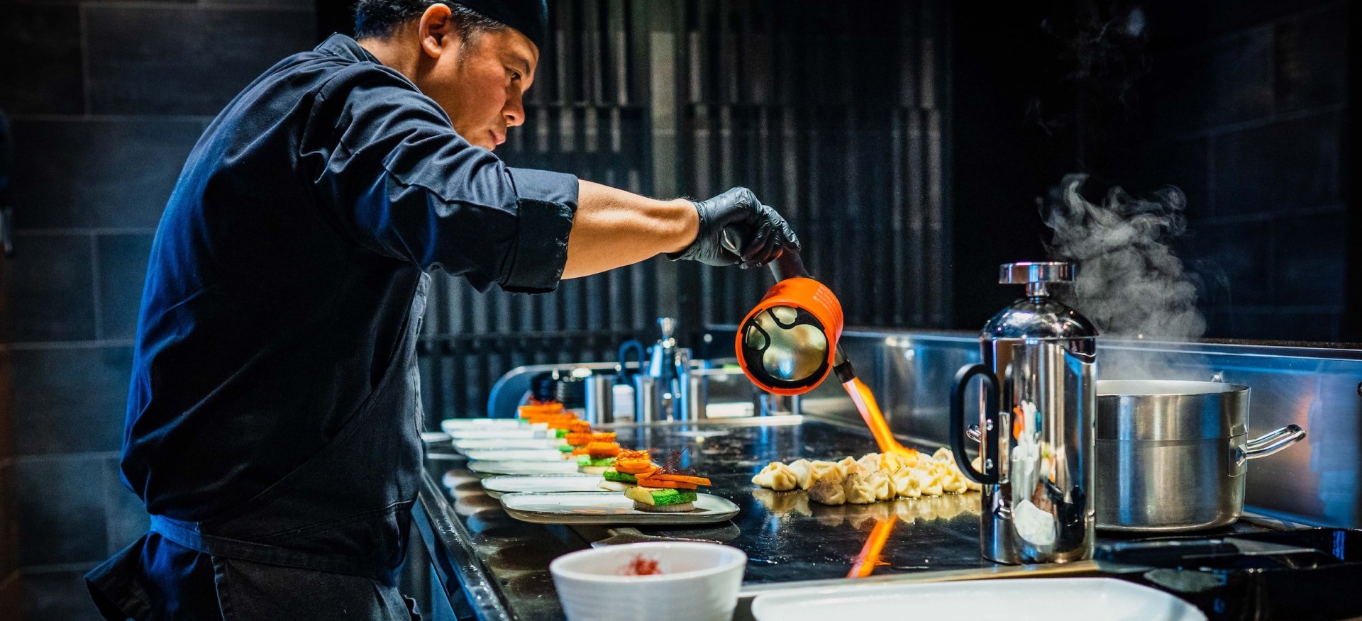 Chef scorching hibachi appetizers before serving them