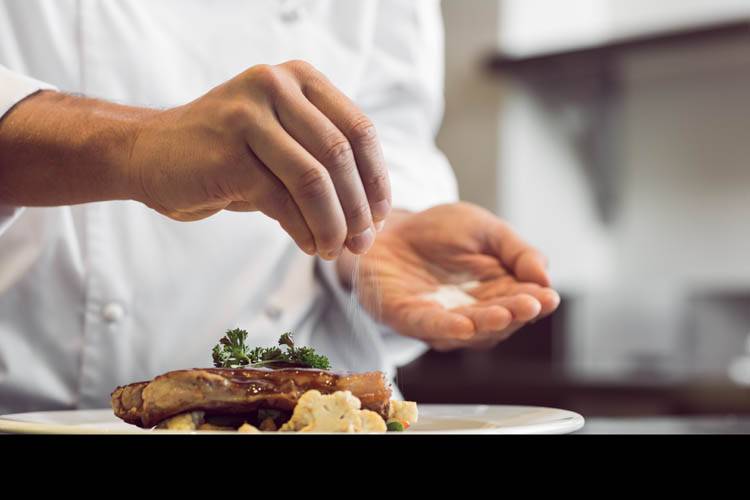 A private chef in Boston finishing the elaboration of a dish A private chef in Boston cooking a dish