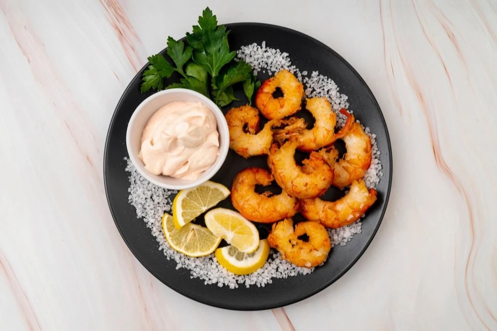 Fried fritters made with shrimp and spices, served with a zesty dipping sauce