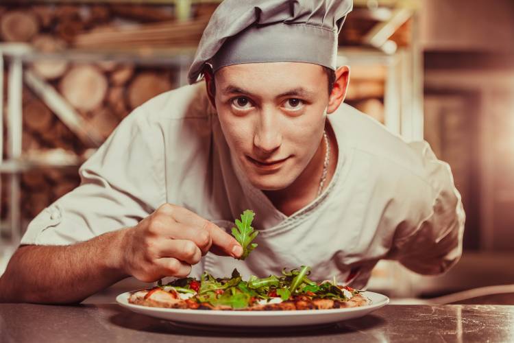 A private chef in St. Catharines finishing the cooking of a dish A private chef in St. Catharines cooking a dish