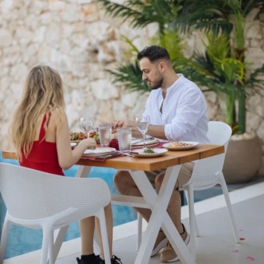 A young couple enjoys a light lunch on a terrace